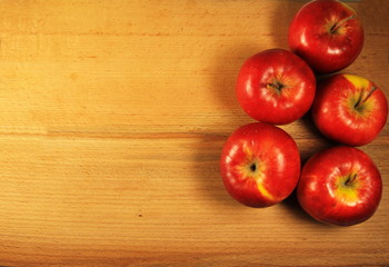 Red apples on wooden background