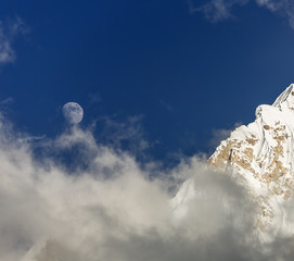 View of the Nuptse (7864 m) and full Moon in the mist (view from the slope of Kala Patthar) -...