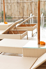 Fototapeta na wymiar Luxury swimming pool and deck chair at the resort