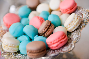 Colorful macarons on a plate on the table