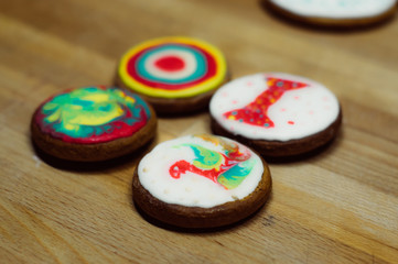 Cookies with pictures on the wooden table, fondant