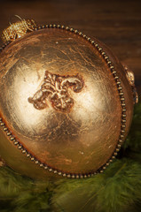 handmade golden chrostmas ball on wooden background