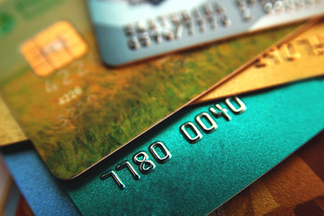 stack of multicolored credit cards, close up view with selective