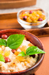 Close-up view of an old wooden bowl of healthy oatmeal