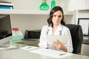 Hispanic female doctor using a tablet