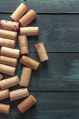 Wine corks on dark wooden texture with copyspace