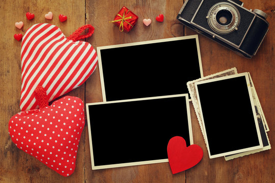 empty photo frames next to old camera and hearts