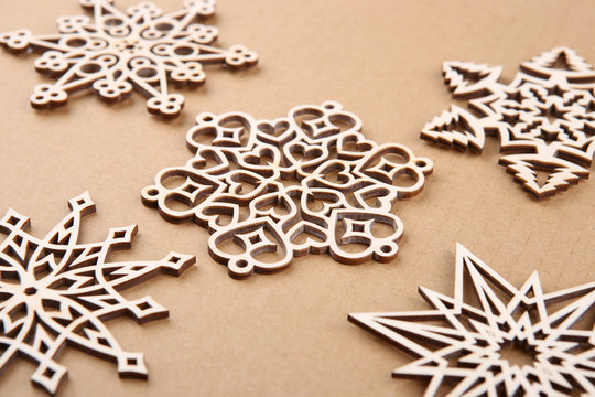 Laser cut wood snowflakes ornaments. Wooden snowflakes on carton. Stock  Photo | Adobe Stock