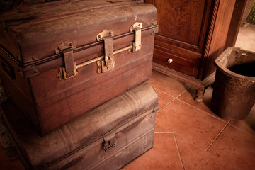 Old wooden antique travel chest used in the past in a stack. Toned image as vintage background.