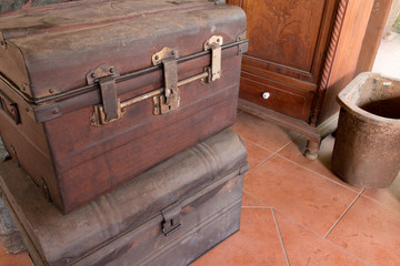 Old wooden antique travel chest used in the past in a stack. Toned image as vintage background.