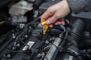 A man are checking engine oil level