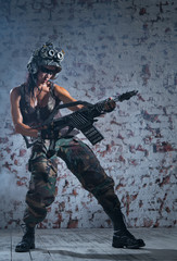 The woman in a protective helmet and with a gun