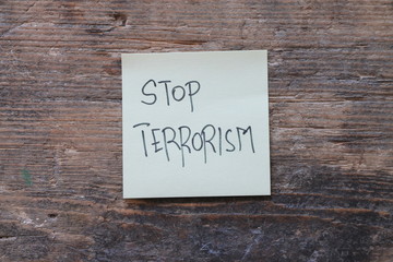 Message Stop terrorism on wooden table