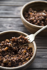 red rice in a clay plate. healthy diet. complex carbohydrates