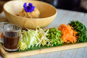 Rice salad set on wood plate, Khao yam, Thai cuisine