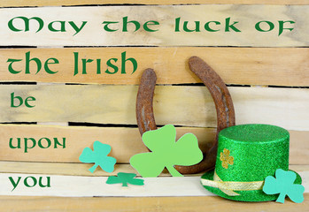 Saint Patrick's Day still life including a glittery green and gold leprechaun hat and a rusty...