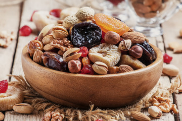 Nuts and dried fruit mix, healthy and wholesome food. Vintage wo