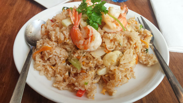 Shrimp fried rice , Asian food fried rice with prawns on in white dish on table.