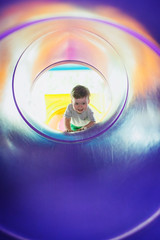 the boy playing on the color playground