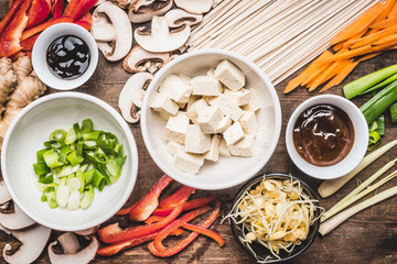 Top view of Asian vegetarian cooking ingredients for stir fry with tofu, noodles and vegetables