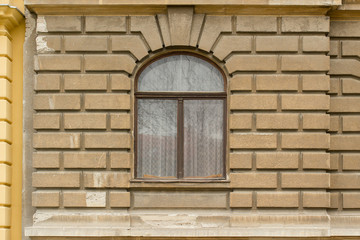 Fototapeta na wymiar Retro looking window on a brown facade 