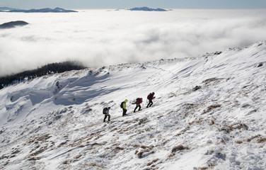 young people make the ascent to the summit. Against the backdrop