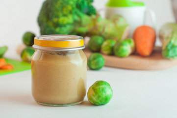 Glass jar with puree with Brussels sprouts