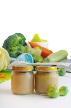 Glass jars with natural baby food on the table