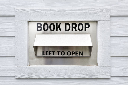 Rural Library Book Drop On Clapboard Wood Wall. Horizontal.