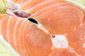 Close up of fresh salmon slices on wood background.