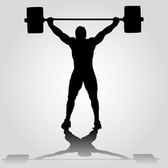 silhouette of athlete is doing snatch exercise. weightlifting