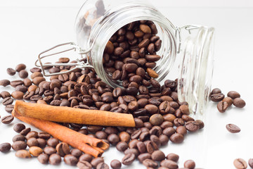 aromatic , fragrant, tasty grain coffee beans scattered on the table, next to the glass Cup as the substrate and background. Coffee beans coarsely. Coffee beans a lot.