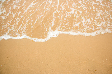 Fototapeta na wymiar Waves on a sandy beach in the summer.