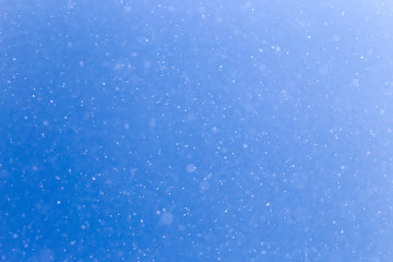 snowing on a blue sky