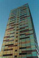 Fototapeta na wymiar Brown and green colored glass windows on building