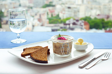 farshmak with butter and bread om white plate