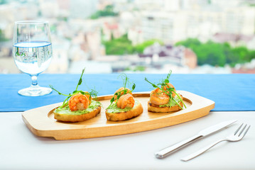 Bruschetta with stewed salmon, cucumber and sauce 