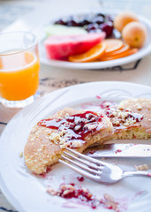 Breakfast including pancakes with raspberry jam