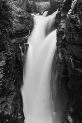 Portrait of high waterfall as part of the Iguazu Waterfall with long exposure in black and white