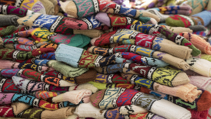 Fototapeta na wymiar Group of handmade colorful knitted socks in the market