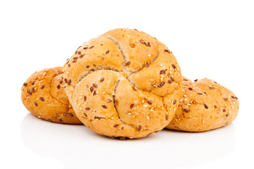 Kaiser roll with sesame seeds, on a white background