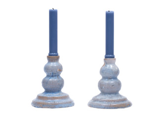 Blue clay ceramic candle holder and blue candle isolated on white background