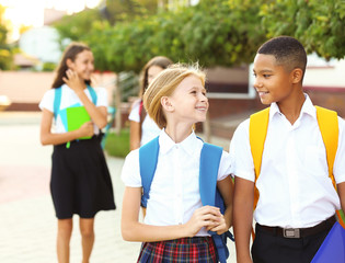 Teenagers with backpacks and notebooks on walking in the park