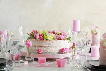 Delicious cake decorated with flowers on blurred background