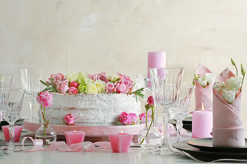 Delicious cake decorated with flowers on blurred background
