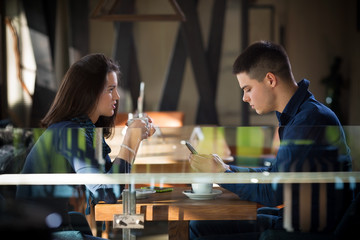 Young daiting couple sitting  in a cafe
