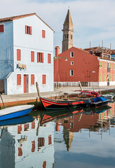 Fototapeta na wymiar The colored houses on the shore of a narrow channel - Burano, Venice, Italy