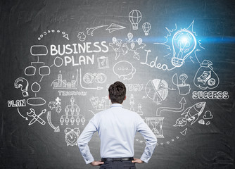 man looking at business plan sketch