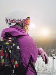Girl in a ski resort. The woman snowboarder in the mountains. Snow, winter, mountain, snowboarding, skiing.