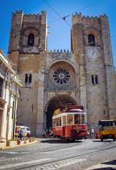 Fototapeta na wymiar Old tram in front of the Lisbon Cathedral, Portugal